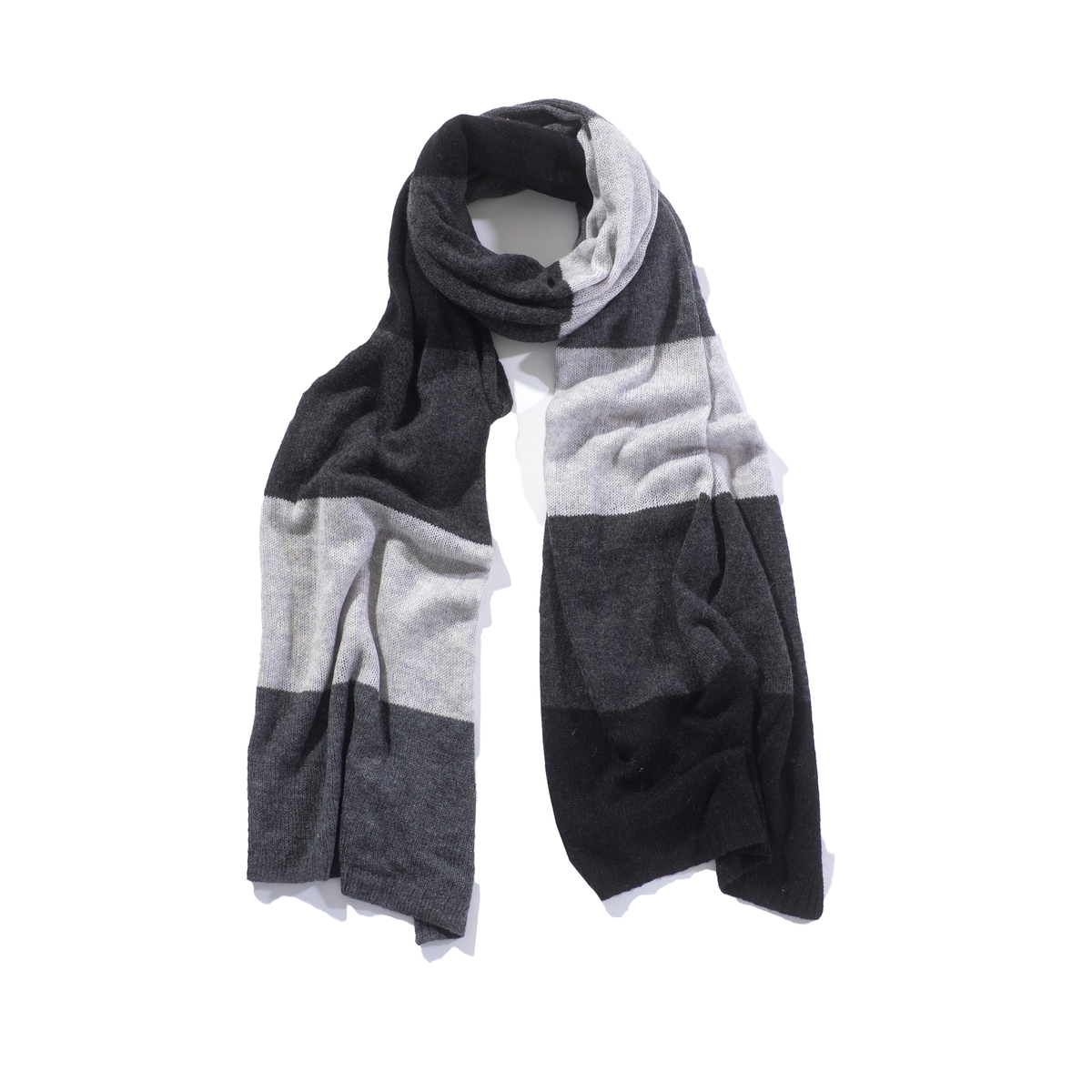 A knit scarf with a color-blocked pattern in black, dark gray, and light gray, draped on a white mannequin torso against a plain white background.