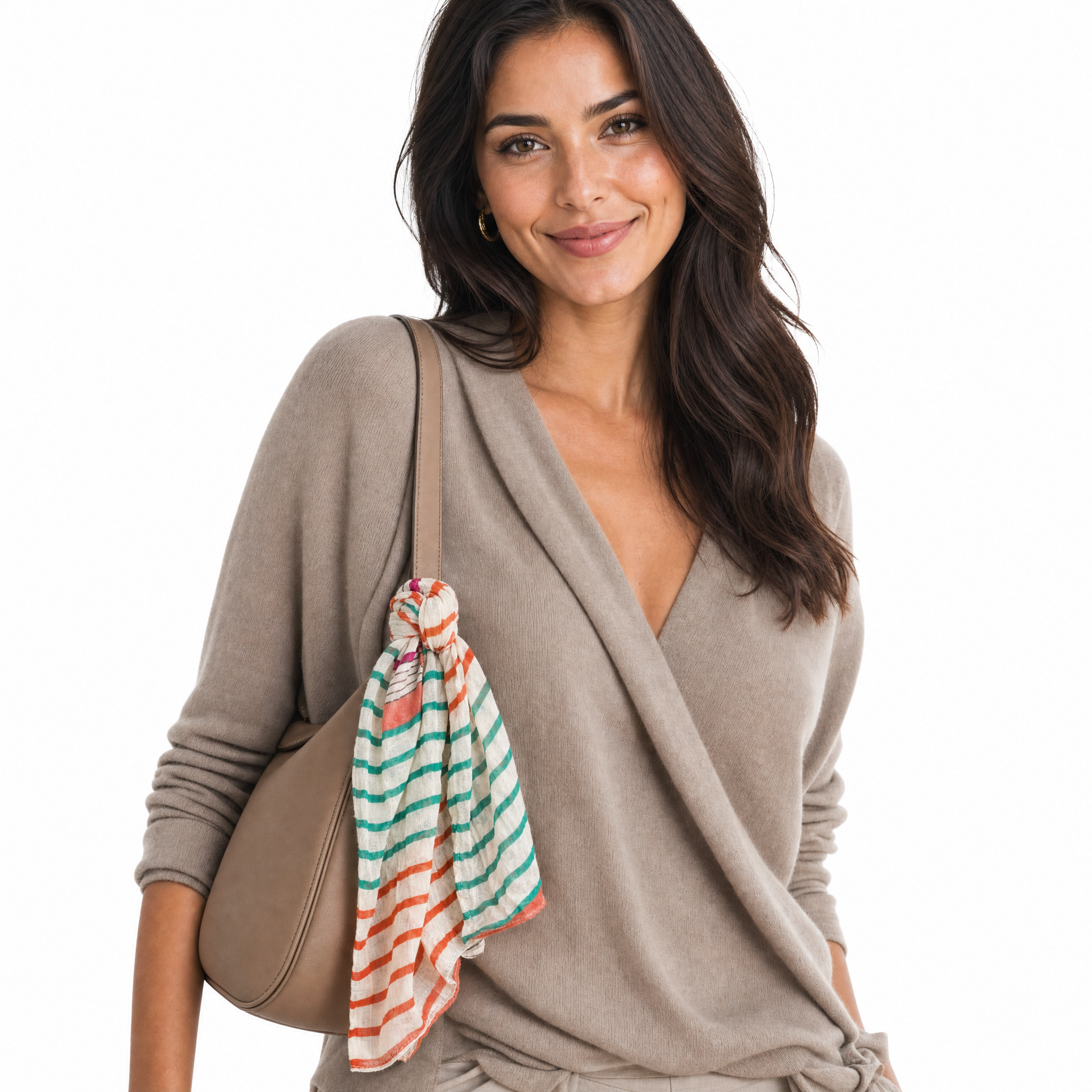Blue Pacific Starburst cotton neckerchief in Coral/Teal, knotted at the base of a handbag strap.